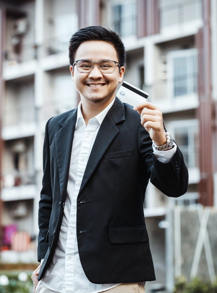 Young Handsome man enjoy shopping online on mobile phone with credit card